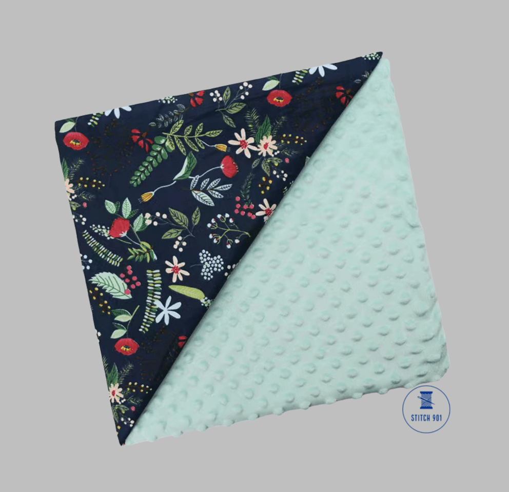 dark green floral fabric with mint green minky backing. baby-size blanket