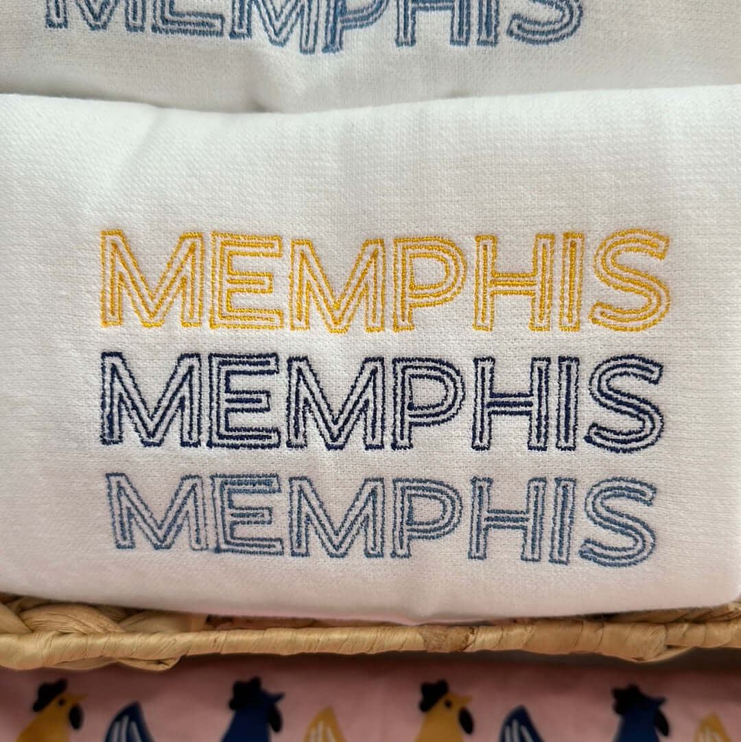 100% cotton tea towel featuring MEMPHIS three times in a stacked design in grizzlies brand colors