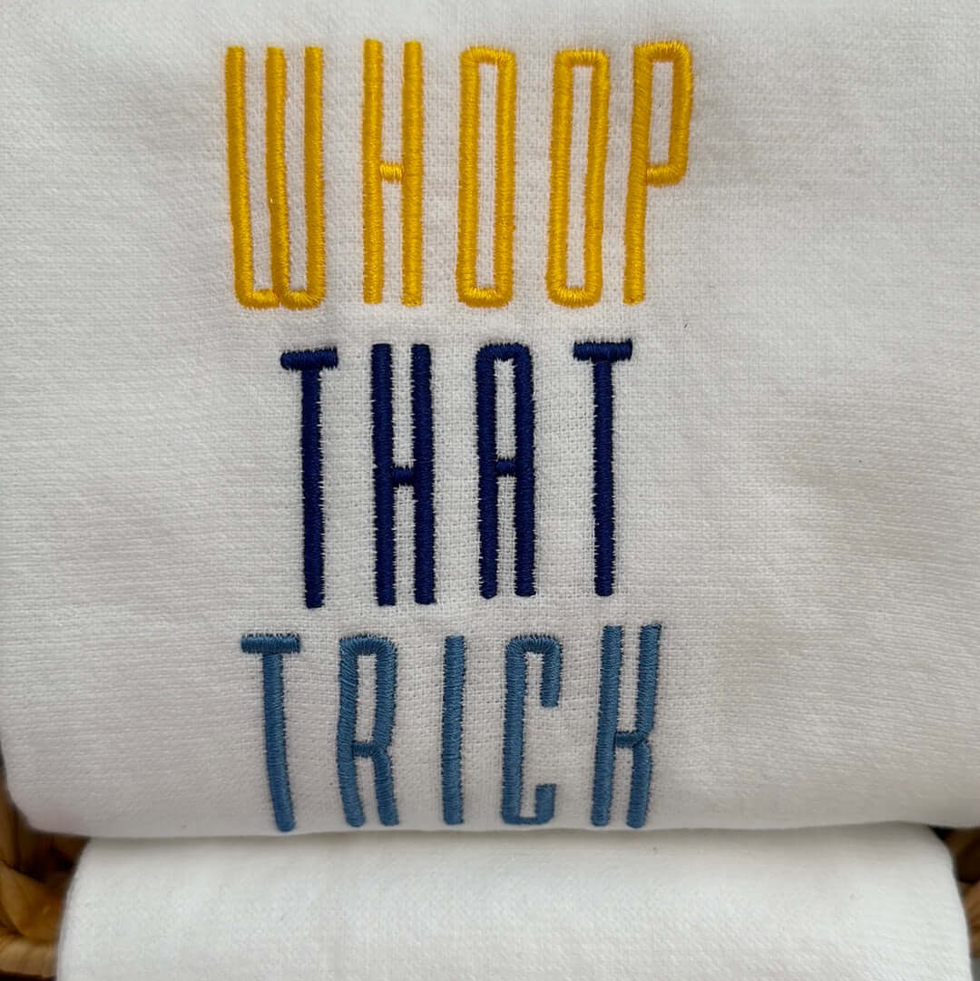 100% cotton tea towel featuring the memphis grizzlies rally phrase, “Whoop that trick” in grizzlies brand colors