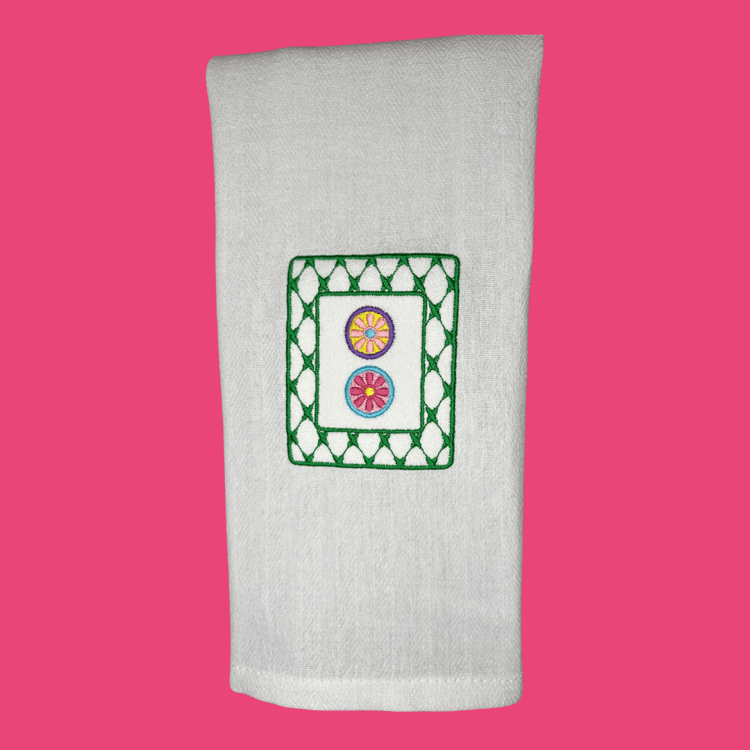 mahjong dot tile embroidered on a tea towel in bright, fun colors
